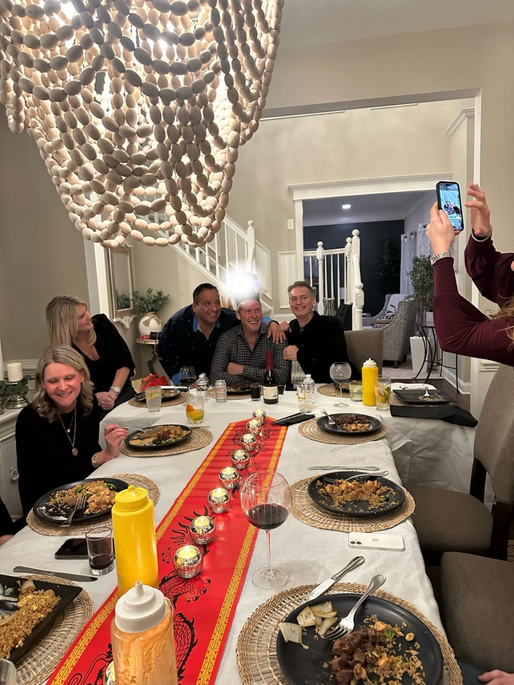 Guests enjoying plated hibachi meals around a dining table indoors